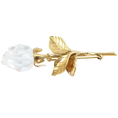 Gold rose with a white stone on a white background