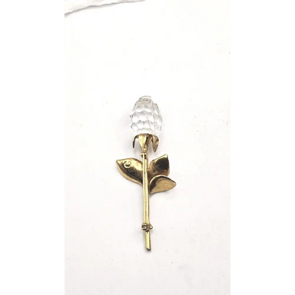 Gold Brooch with a clear crystal on a white background
