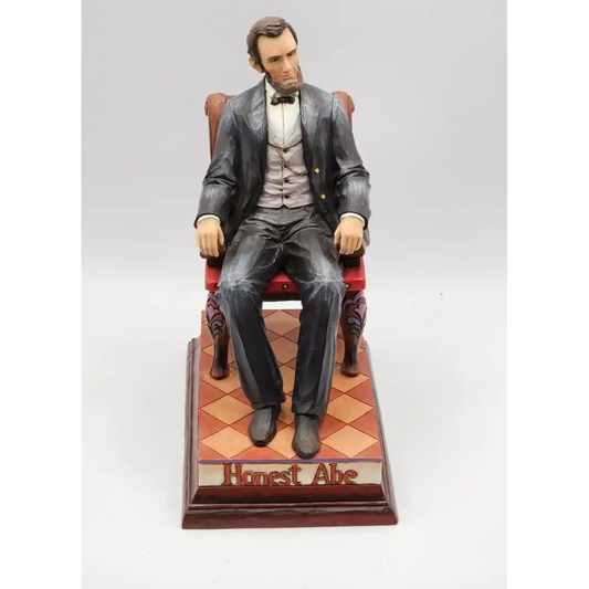 Statue of a man in formal attire sitting