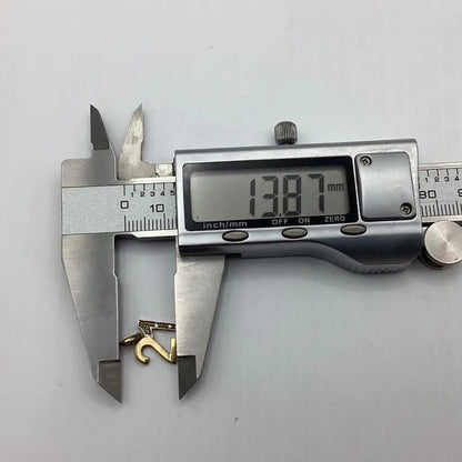 Digital caliper measuring a gold ring