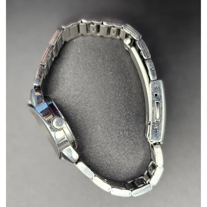 Metallic watch on a gray background
