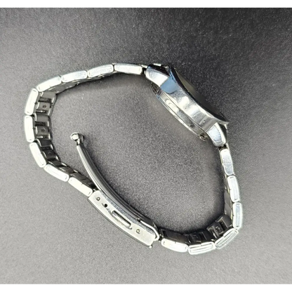 Metallic watch on a gray background
