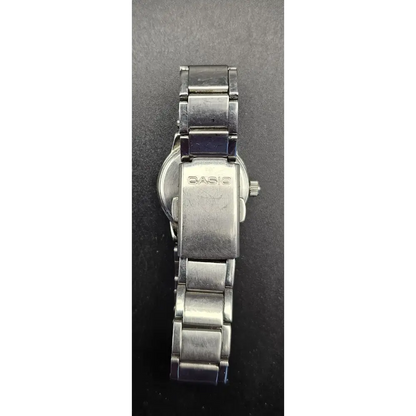 Silver Casio watch on a dark gray background