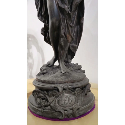 Bronze statue on a pedestal with 'HERB' engraved