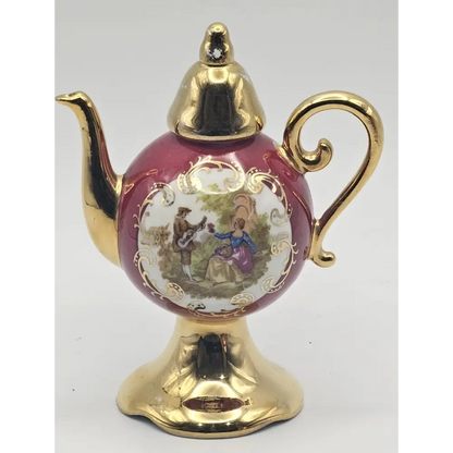 Decorative teapot with gold accents and a detailed design 