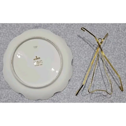 White ceramic plate with gold detailing on a textured gray surface