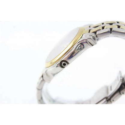 Close-up of a watch with a gold and silver band