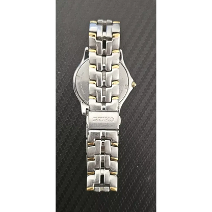Silver Seiko watch on a textured black