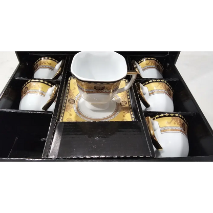 Set of white ceramic cups with gold accents