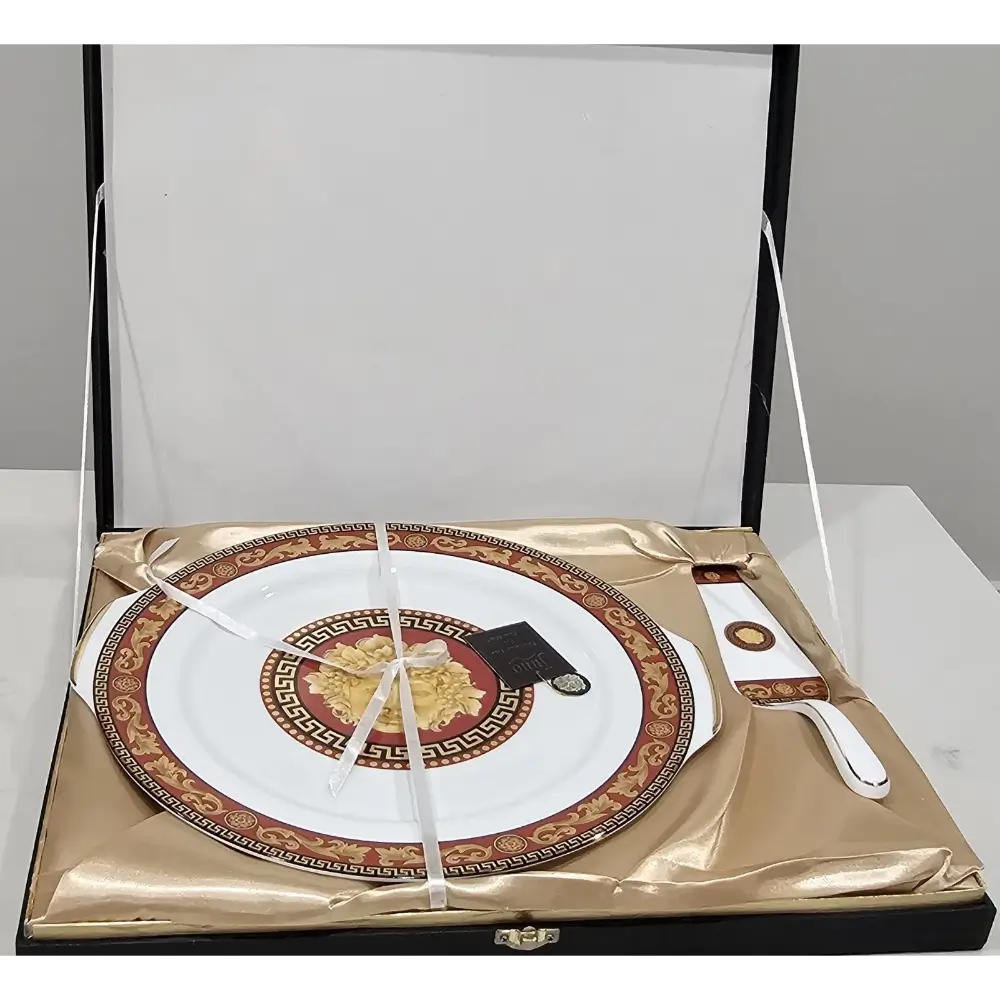 Decorative plate with gold and red design on a white background