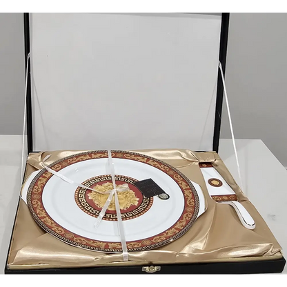 Decorative plate with gold and red design on a white background