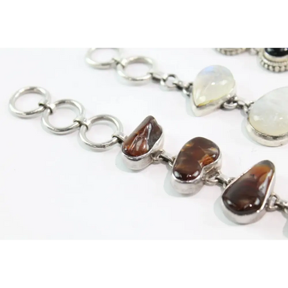 Silver bracelet with heart-shaped gemstones on a white background