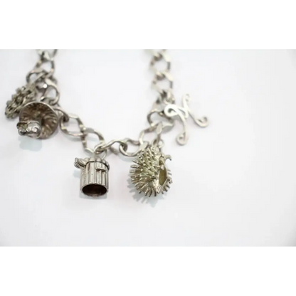 Silver charm bracelet with various charms 