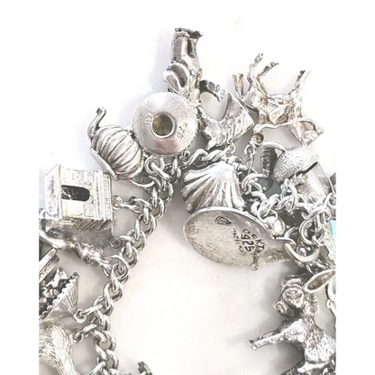 Silver charm bracelet with various charms 