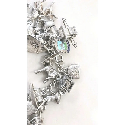 Silver charm bracelet with various charms 