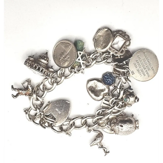 Silver charm bracelet with various charms 