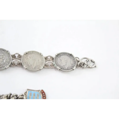 Silver bracelet with coin charms on a white background