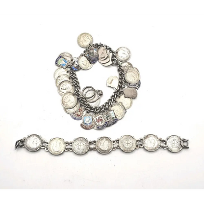 Silver charm bracelet with various charms on a white background