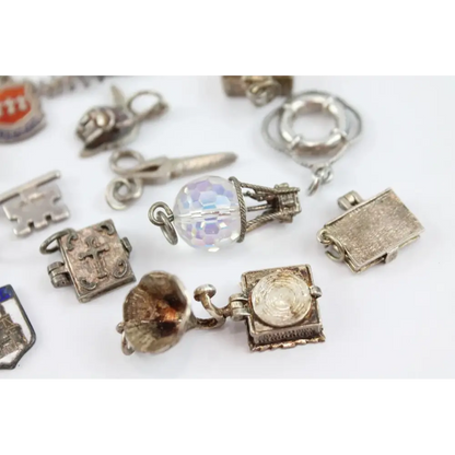 Collection of various silver charms on a white background