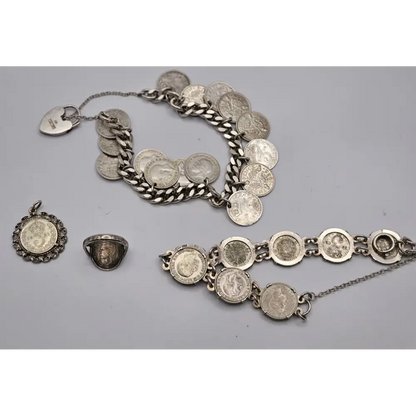 Silver jewelry set including a bracelet, necklace, and ring on a gray background