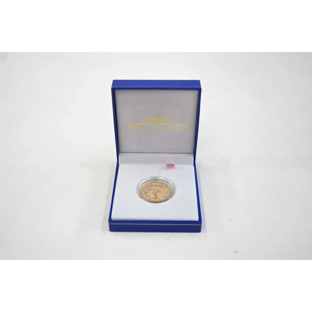 Gold coin in a blue box on a white background
