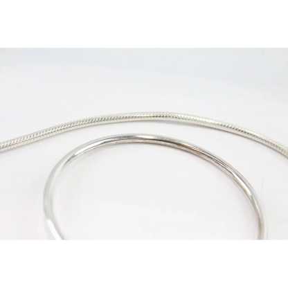 Silver bracelet on a light gray background