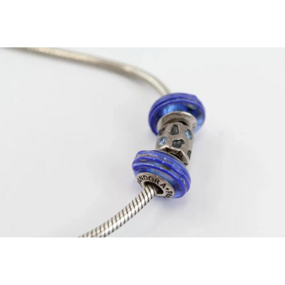 Silver bracelet with blue beads on a white background