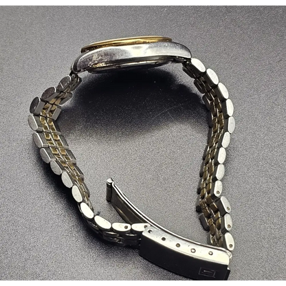 Metallic watch strap on a gray background
