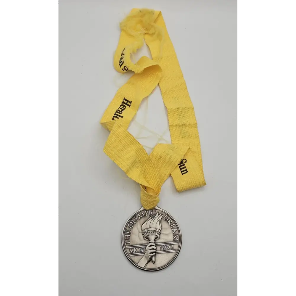 Close-up of engraved Sarah Durack 1912 Olympic gold medal design featuring swimmer portrait