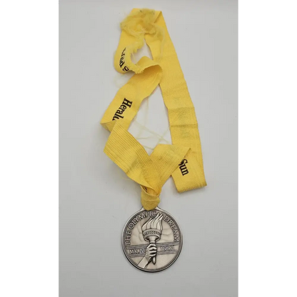 Close-up of engraved Sarah Durack 1912 Olympic gold medal design featuring swimmer portrait