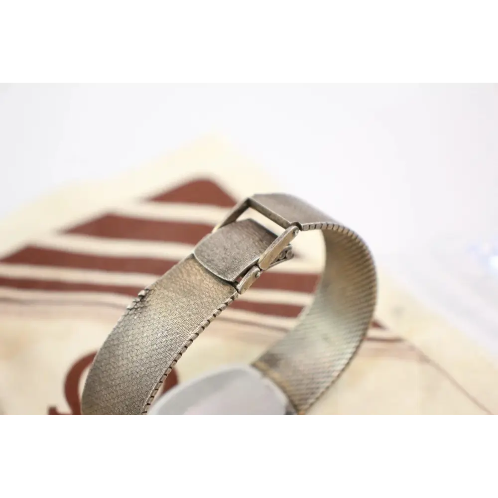 Close-up of a metallic bracelet on a blurred background