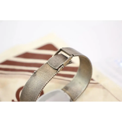 Close-up of a metallic bracelet on a blurred background