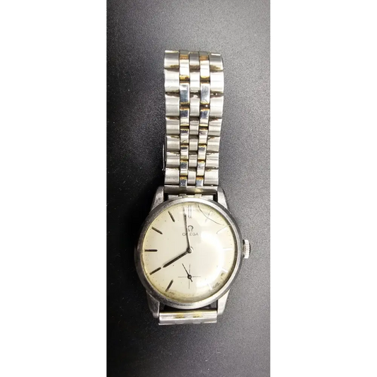 Silver wristwatch with a white face on a dark gray background