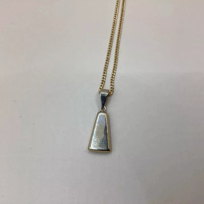 Silver pendant on a gold chain