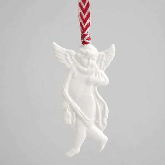 White angel ornament with a red and white striped ribbon on a light gray background