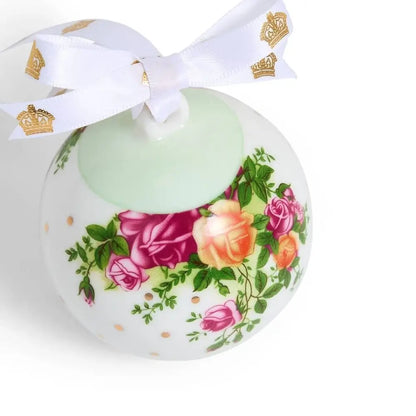 Decorative ball with floral design and white ribbon on a white background