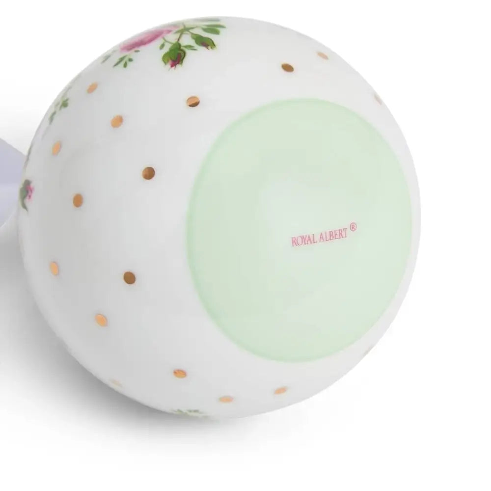 Round ceramic object with floral design and 'Royal Albert' branding