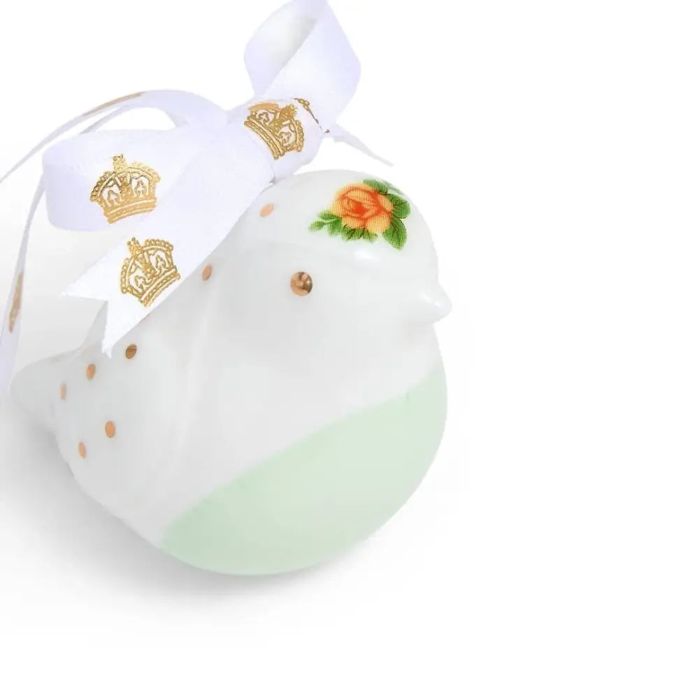 Decorative ceramic dove with gold accents and a white ribbon