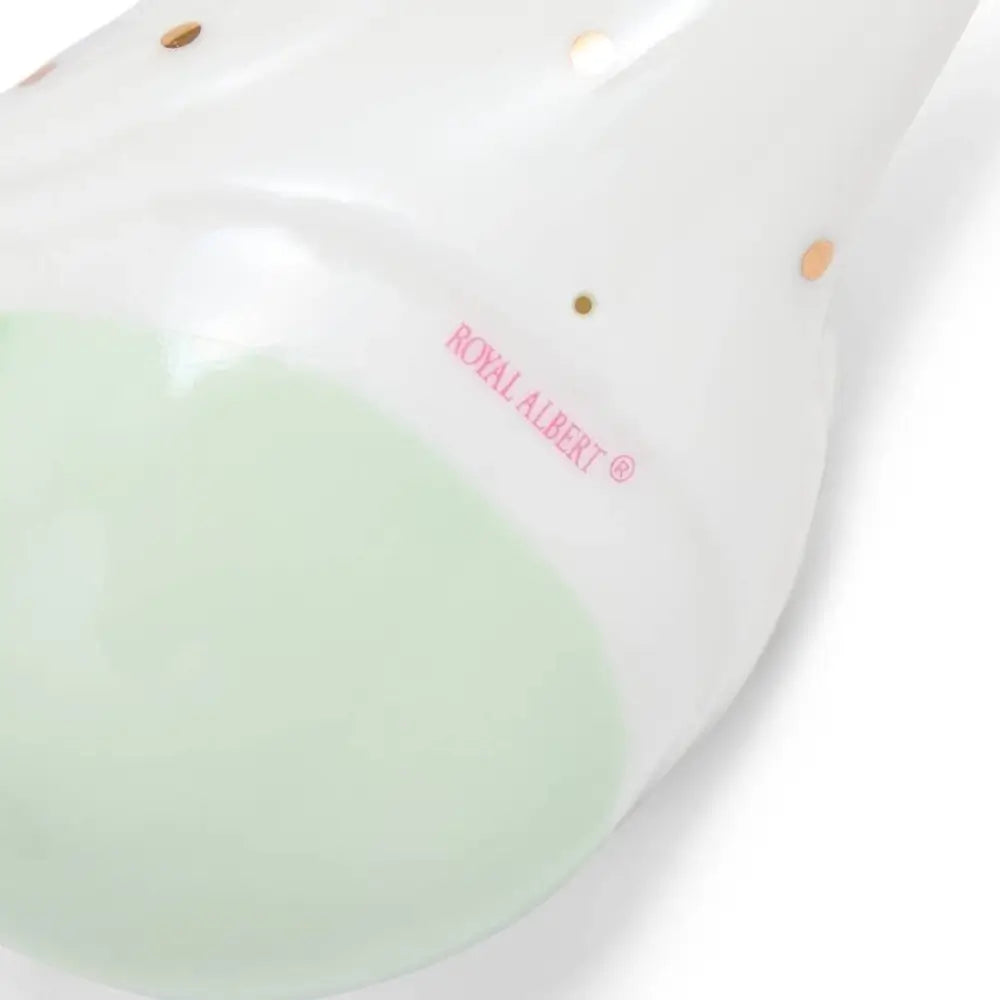 White ceramic ornament with green center and 'Royal Albert' branding 