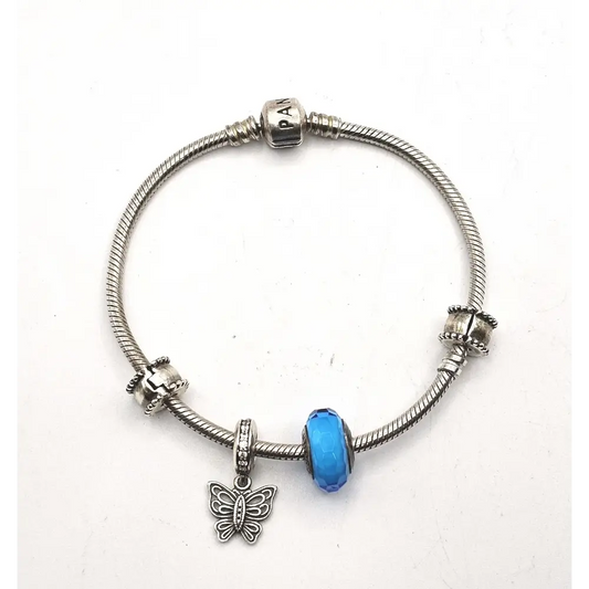 Silver bracelet with a blue bead and butterfly charm
