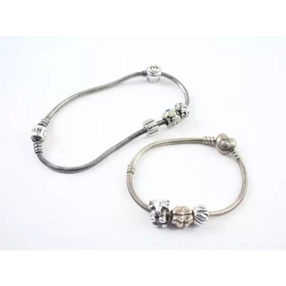 Silver bracelet with floral charm on a white background