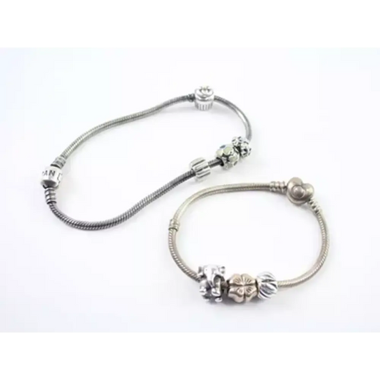 Silver bracelet with floral charm on a white background