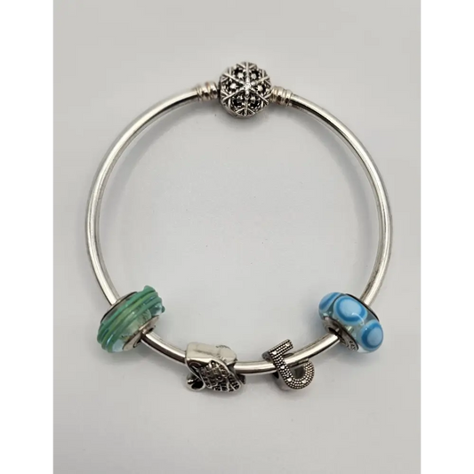 Silver bracelet with colorful beads on a light gray background