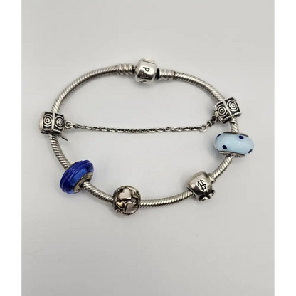 Silver bracelet with colorful beads on a light gray background
