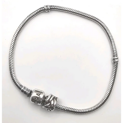 Silver bracelet with a clasp on a white background