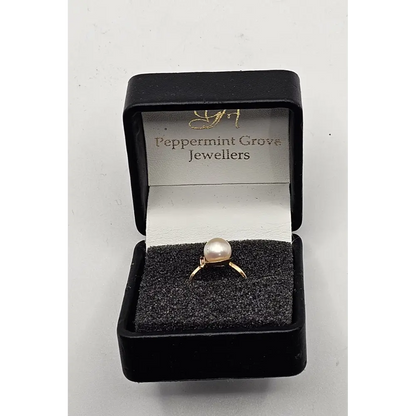 Gold ring with a pearl in a black box labeled 'Peppermint Grove Jewellers'