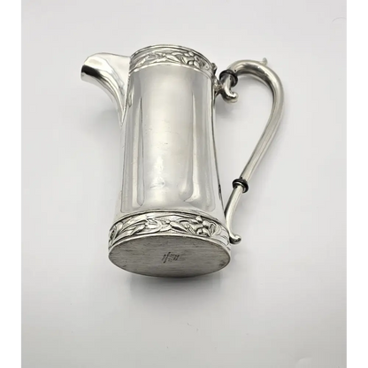 Silver pitcher with decorative elements