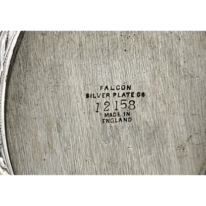 Close-up of a silver plate with 'Falcon Silver Plate Co' branding