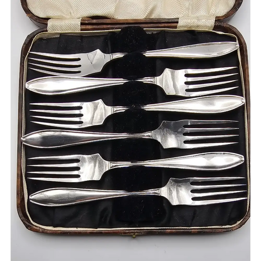 Set of silver forks in a case