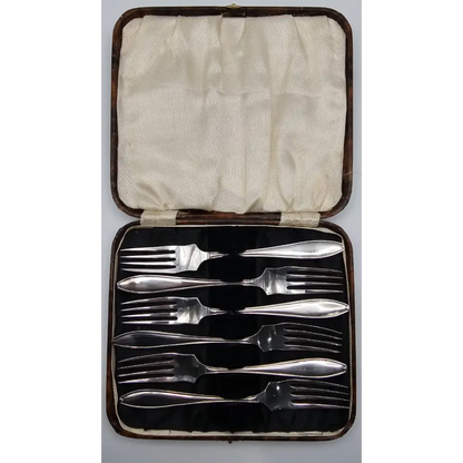 Set of silverware in a case on a white background